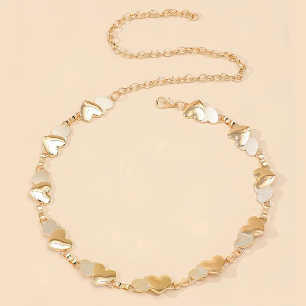 Gold chain belt with heart-shaped accents for elegant style, perfect accessory