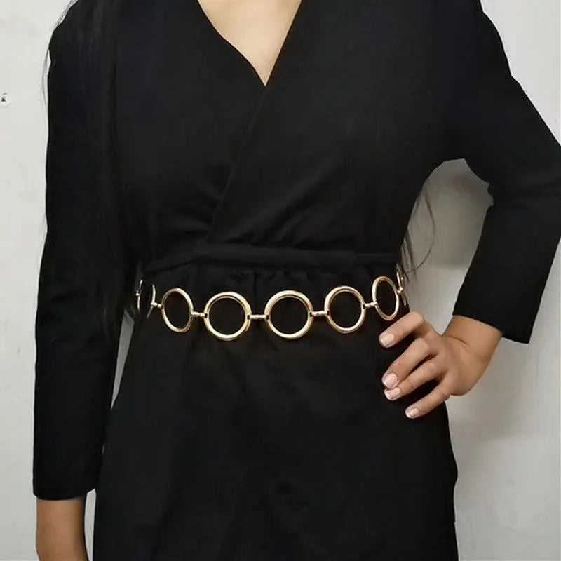 Black dress with a stylish gold chain belt featuring a circular detail for elegant looks