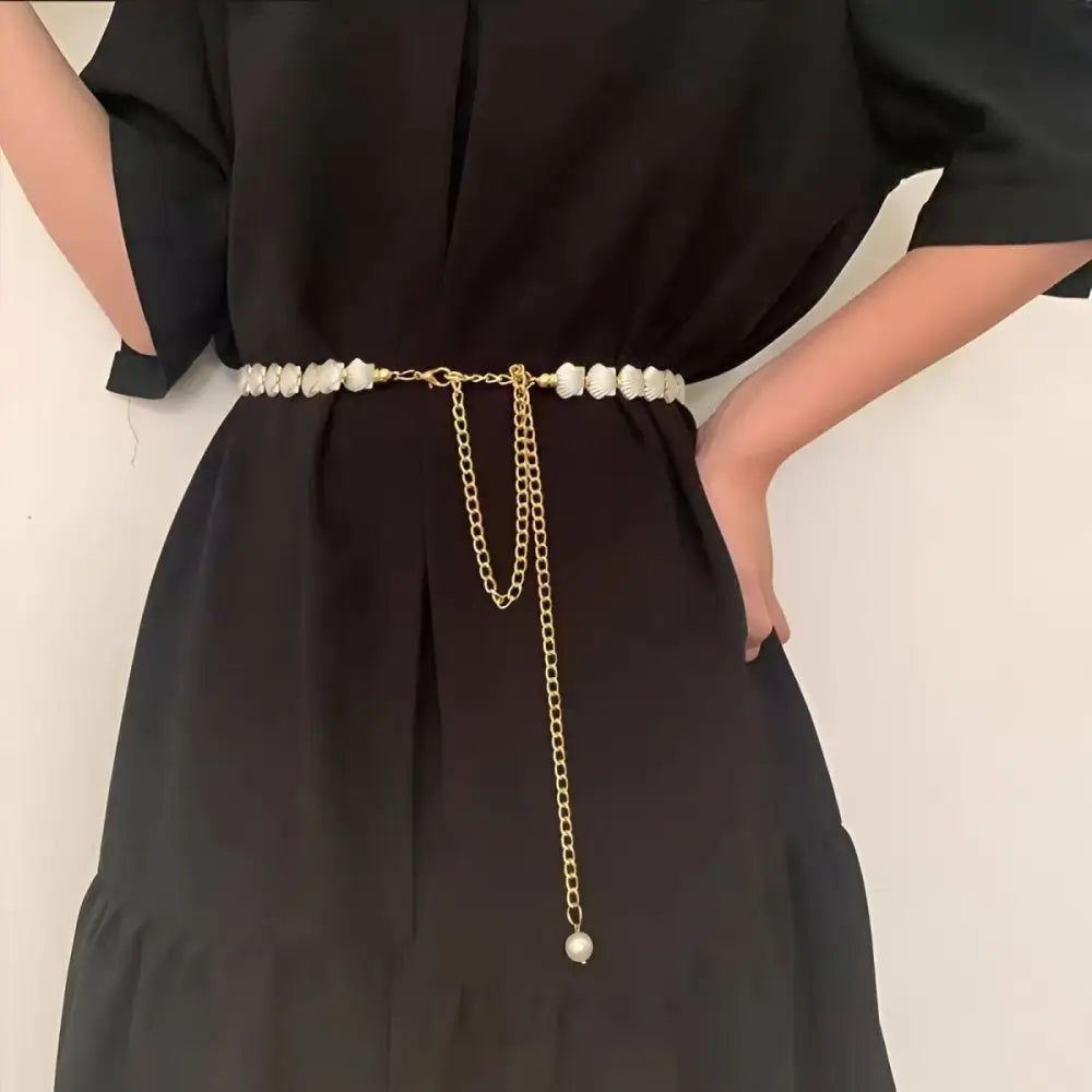 Black dress with vera chain belt featuring beaded and chained accents for elegant style