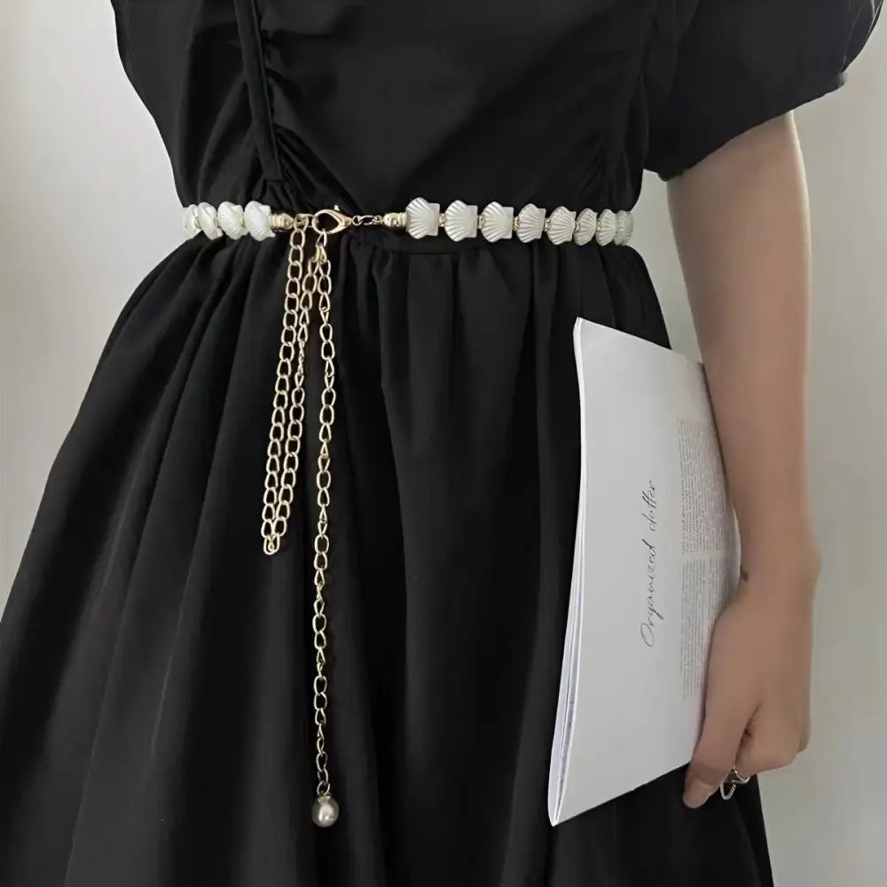 Black dress with vera chain belt featuring seashell accents from Elegant Dresses collection
