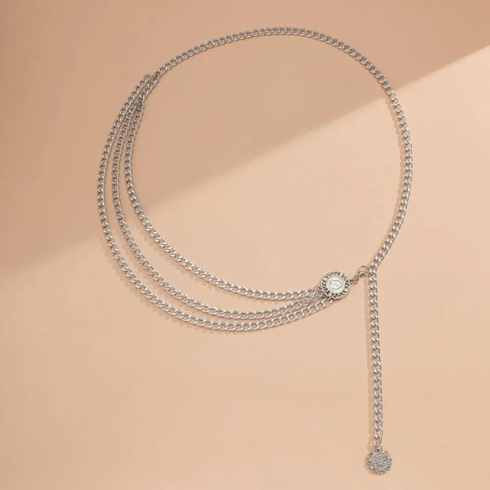 Silver chain belt with medallions from Gold and Silver Chain Belts with Layered and Embellished Designs