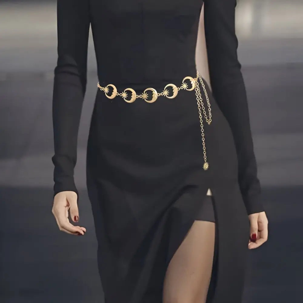 Black dress featuring a gold-toned Moon and Star Zilya Chain Belt for elegant style