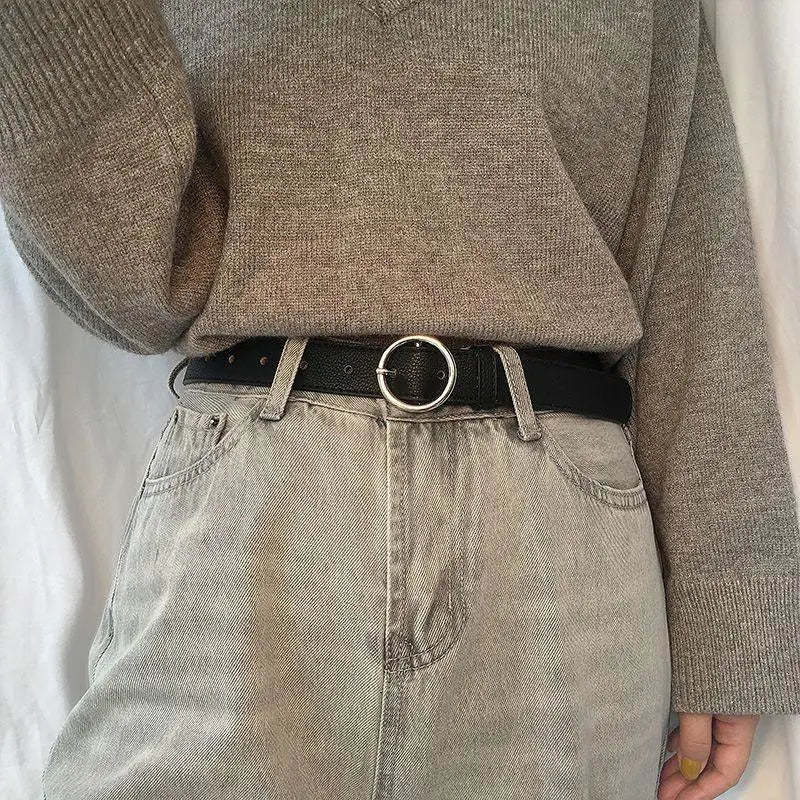 Gray jeans with black belt featuring Murielle Belt Black Leather with Circular Silver Buckle