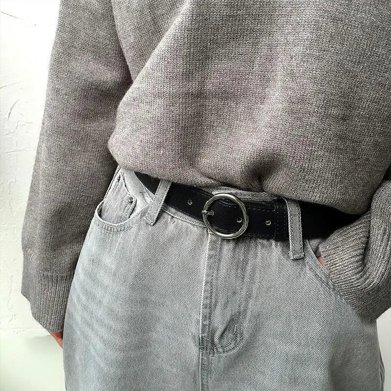 Gray jeans with black belt featuring Murielle Belt Black Leather with Circular Silver Buckle