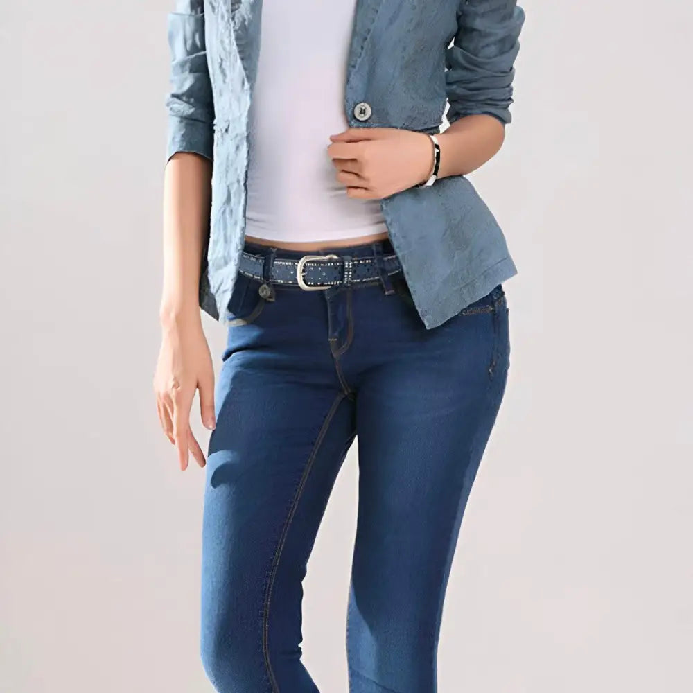 Woman wearing a denim outfit accessorized with a black leather belt featuring a silver studded buckle