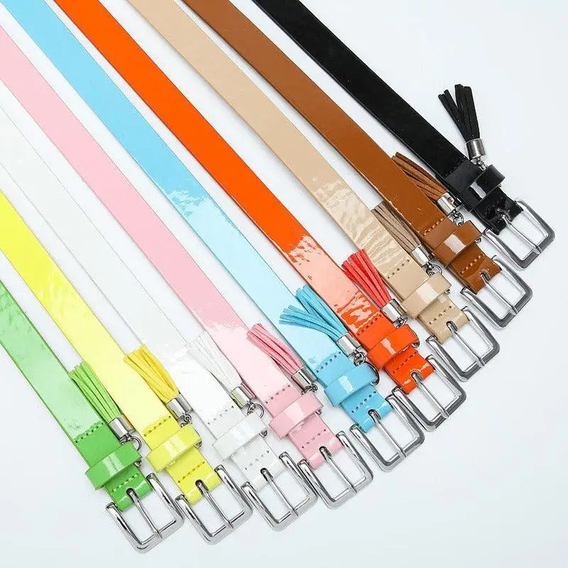 Colorful patent leather women’s belt with tassels and silver buckle for stylish outfits