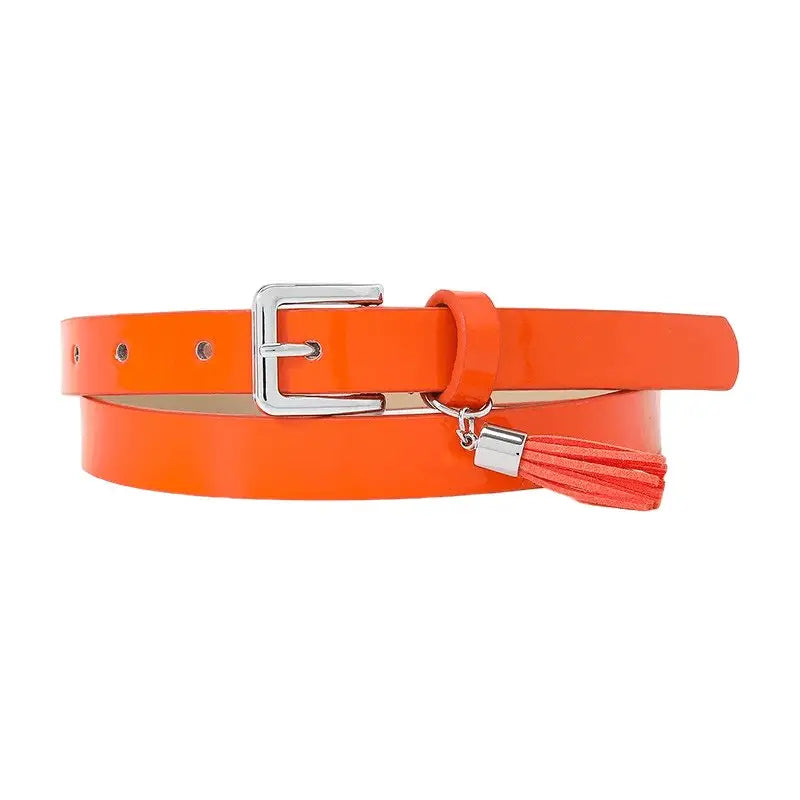 Orange patent leather women’s belt with silver buckle and tassels for stylish accessories