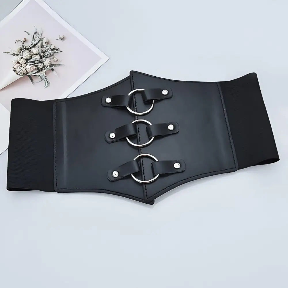 Black faux leather corset belt with metal rings for stylish wear