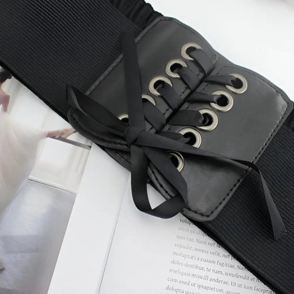 Elegant black corset belt with ribbon lacing for stylish occasion wear