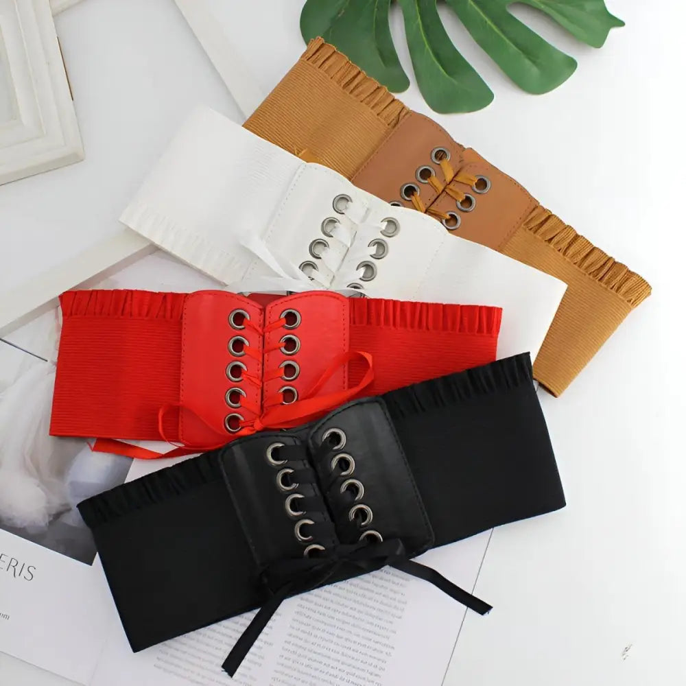 Elegant corset belt display in brown white red and black for stylish occasion wear
