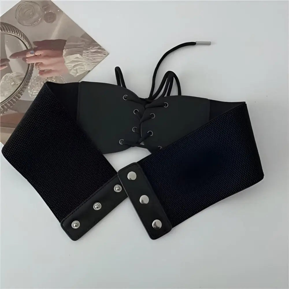 Black corset belt with elastic sides and lace-up front for elegant styling