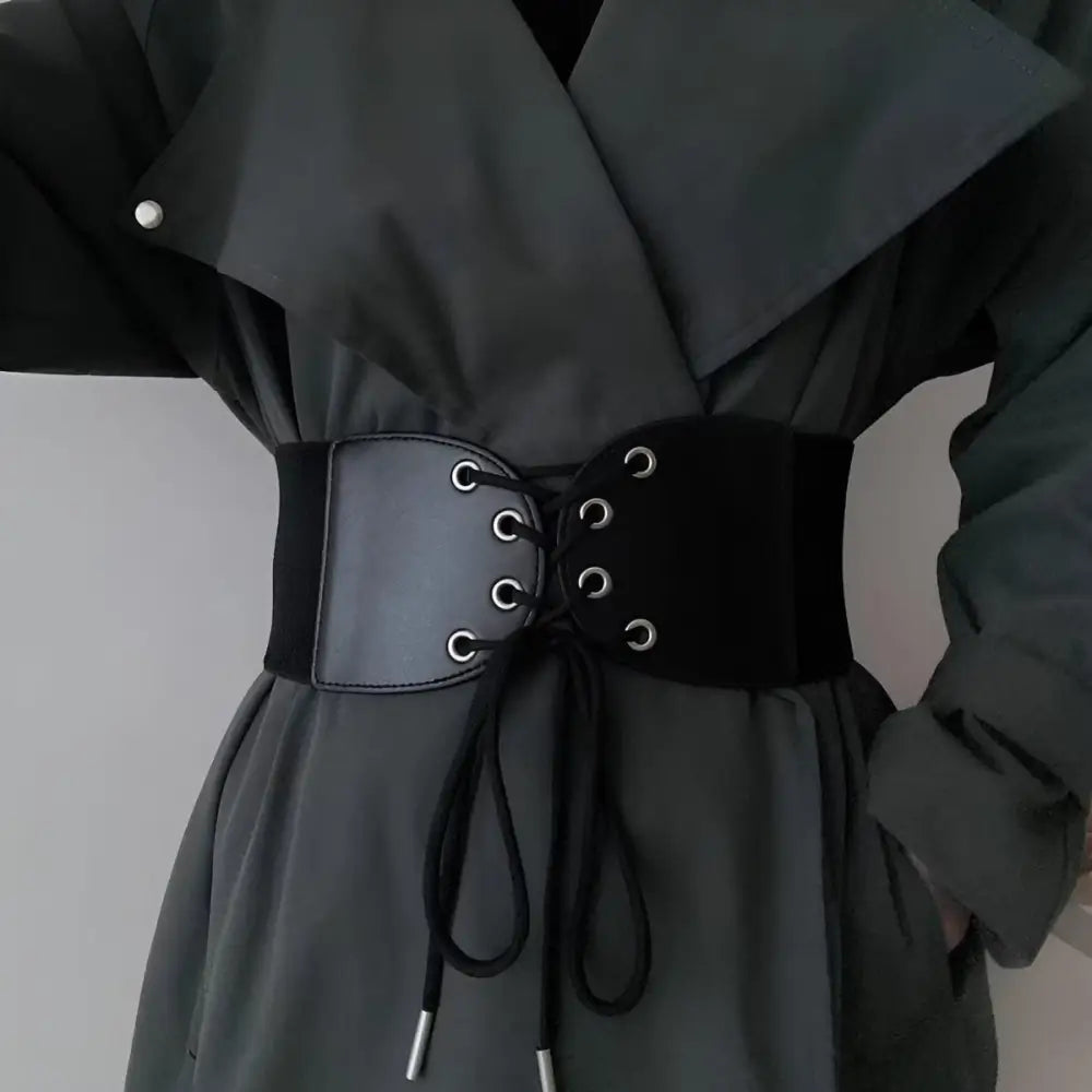 Black corset belt with silver grommets for elegant styling and chic accessory