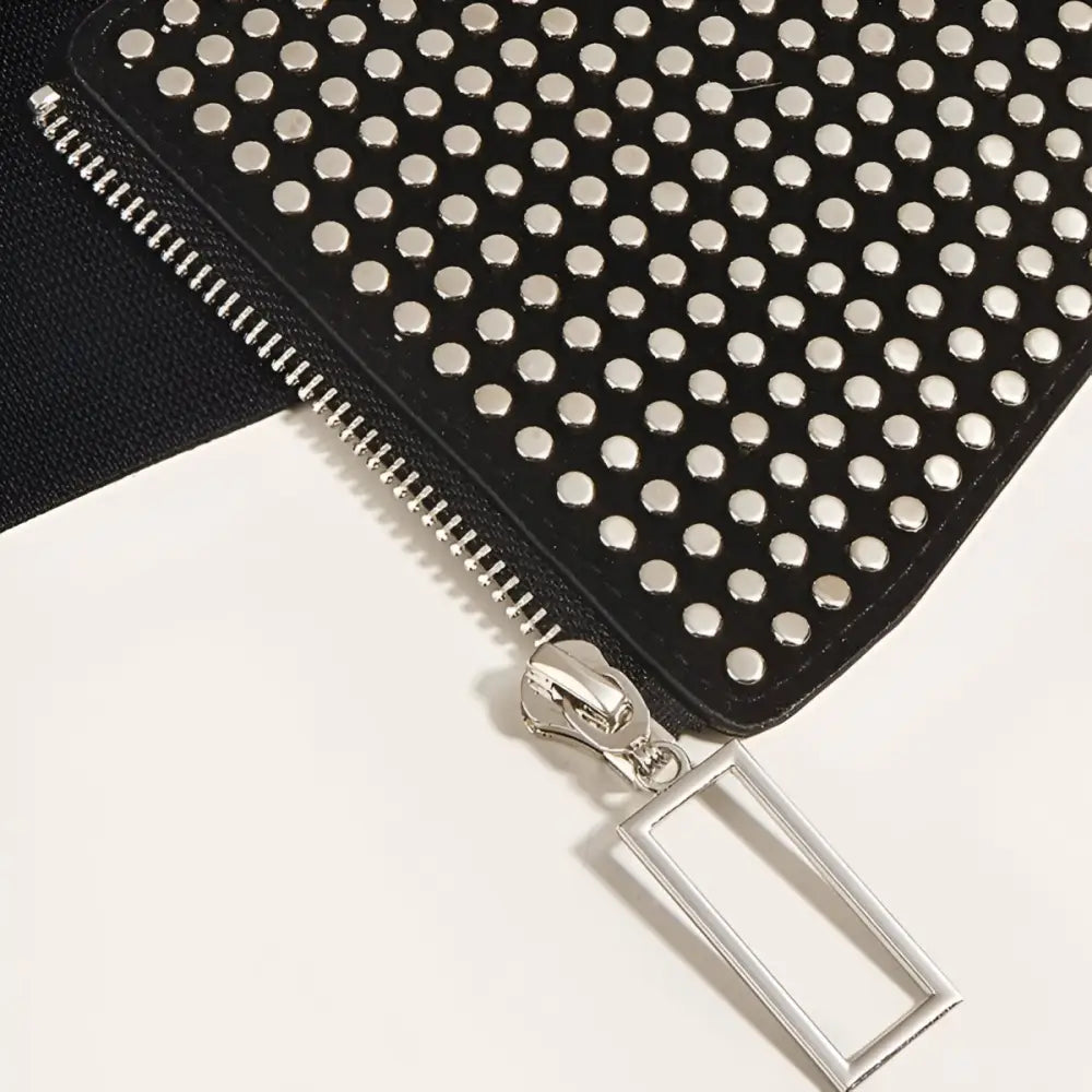 Black studded wallet with zipper displayed on Nolwenn Zip Corset Belt for elegant style