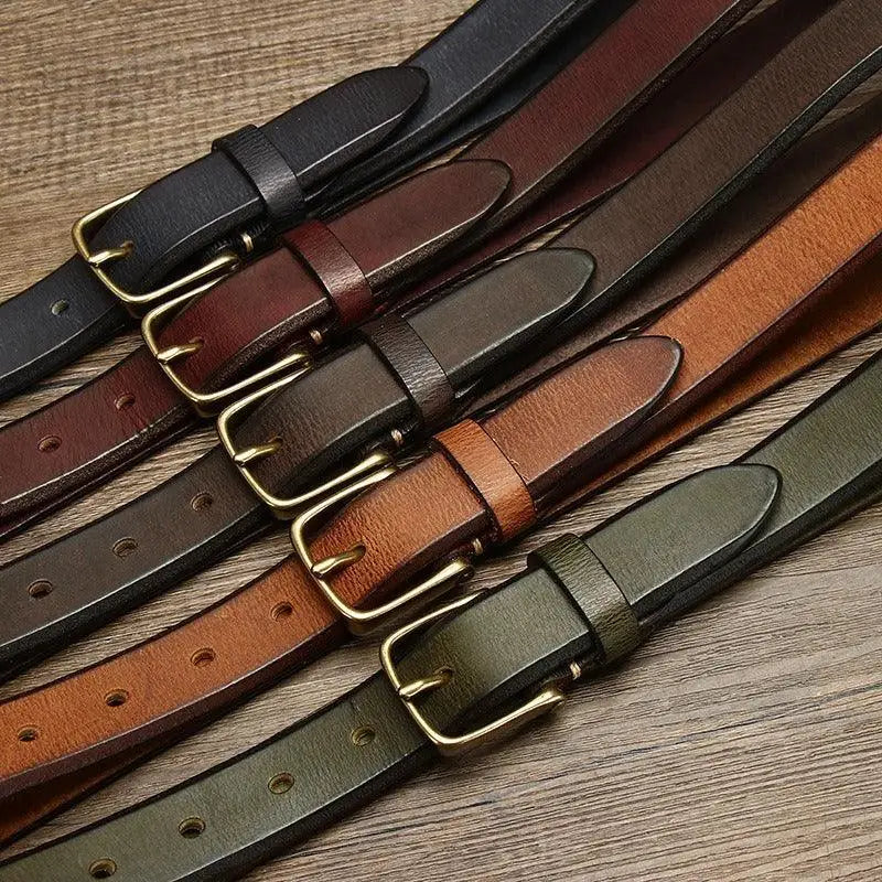 Assorted leather belts with brass and gold buckles for stylish men’s accessories