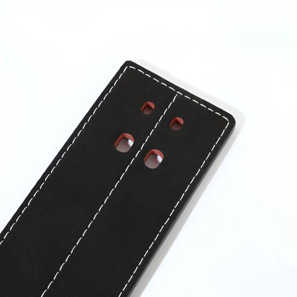 Black leather powerlifting belt with white stitching and red-lined holes for support