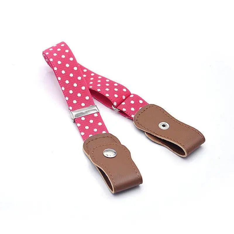 Pink polka dot suspenders paired with denim shorts and an orange belt for a stylish look