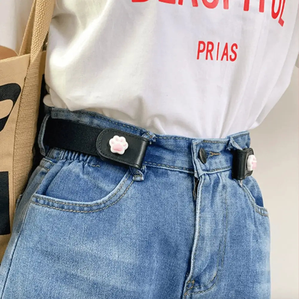 Girl’s Lavender Eulalie Belt with cartoon button and cat paw closures on blue jeans