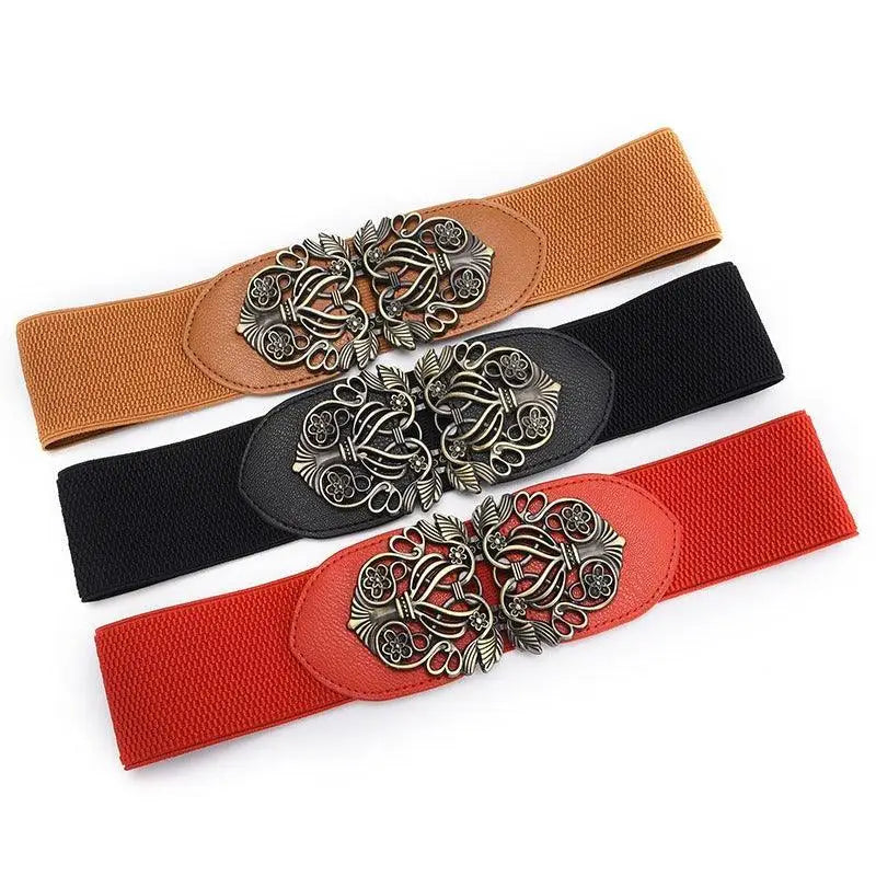Three elastic waist belts with decorative silver clasps displayed with Floral Dress