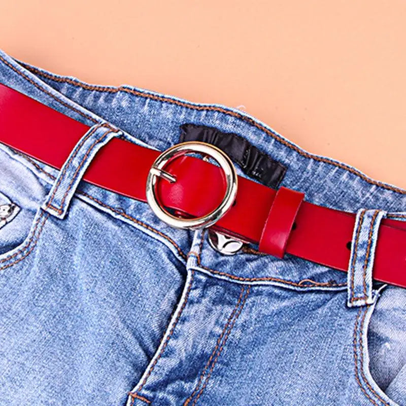 Blue denim jeans with a Khatia Leather Belt featuring a gold or silver buckle for men and women