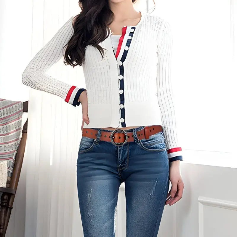Woman wearing a white cardigan with red and blue trim from the Red Leather Belt and White Cardigan collection