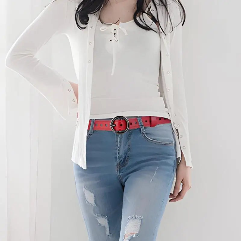 Red leather belt worn with white cardigan with red and blue trim