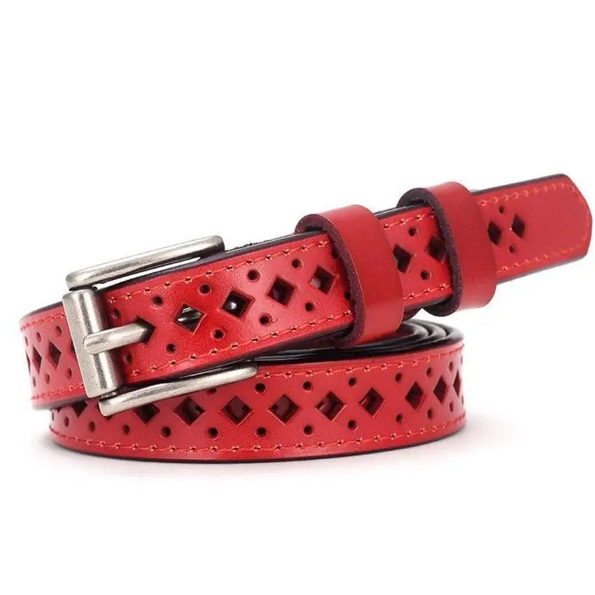 Red leather belt with diamond cutouts displayed on distressed denim shorts for stylish wear