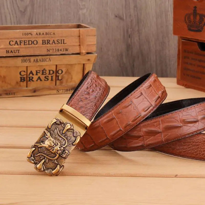 Brown crocodile leather belt featuring an intricate dragon buckle design