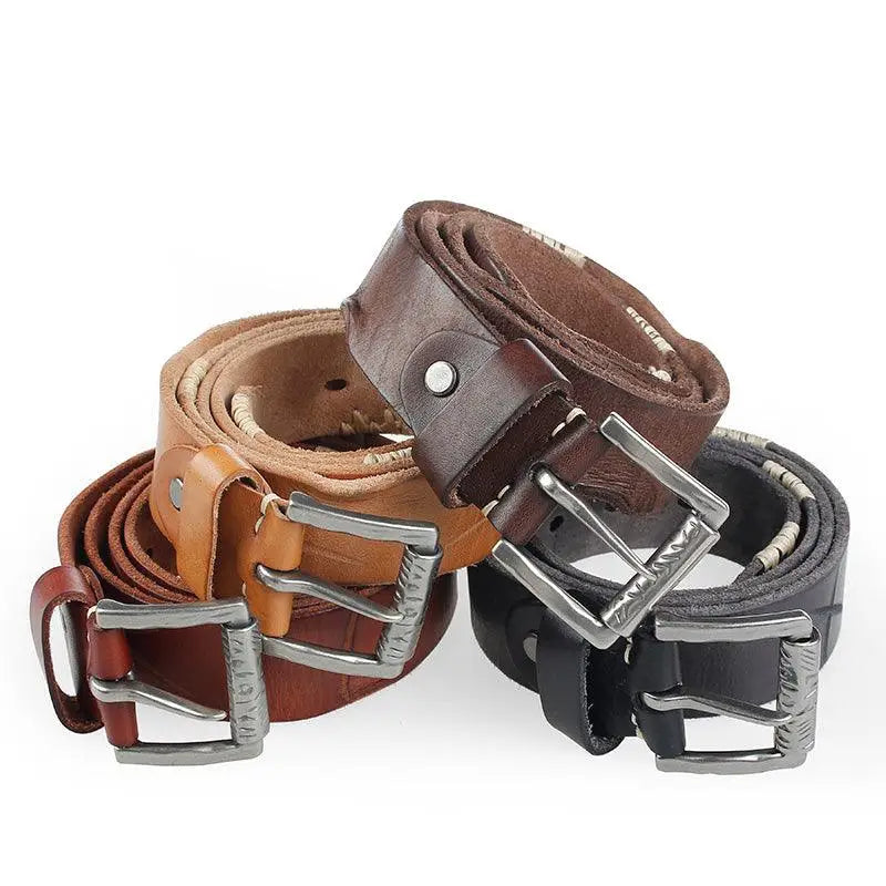 Pile of leather belts displayed with a Denim Vest featuring a brown leather belt and silver buckle