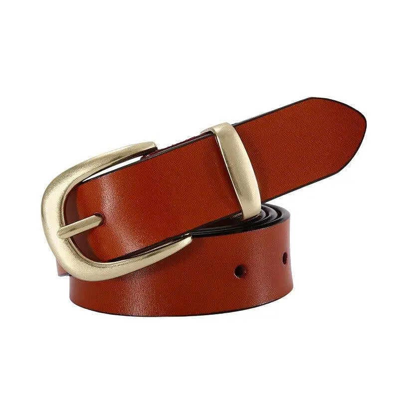 Brown leather belt with a prominent golden buckle paired with distressed blue jeans