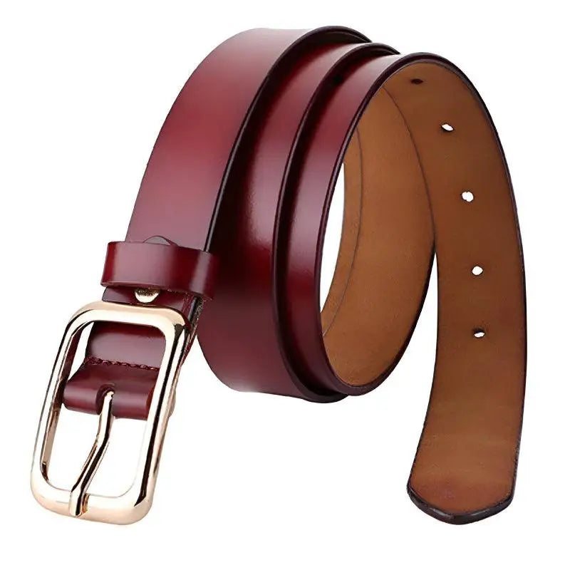 Burgundy leather belt with gold buckle displayed with white sweater and blue jeans