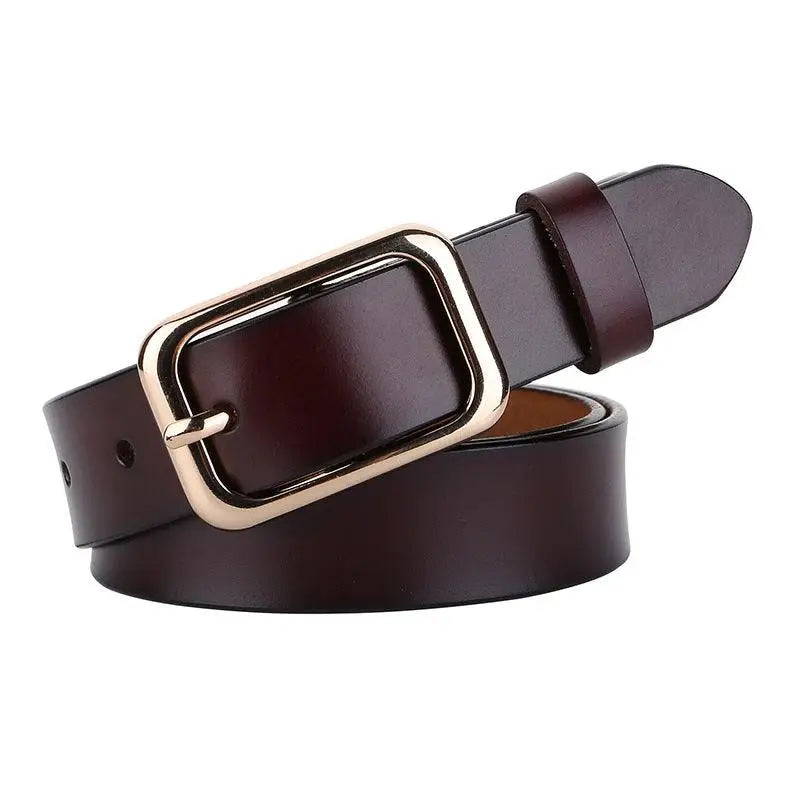 Brown leather belt with a gold buckle showcased in a woman’s white sweater and blue jeans outfit