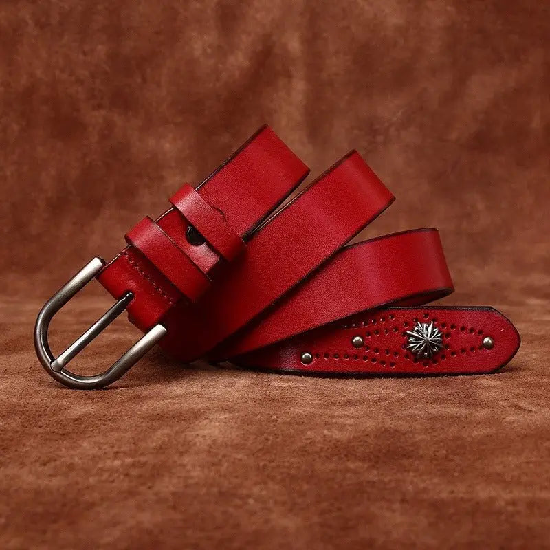 Red leather belt with silver buckle and starburst embellishment for stylish accessories