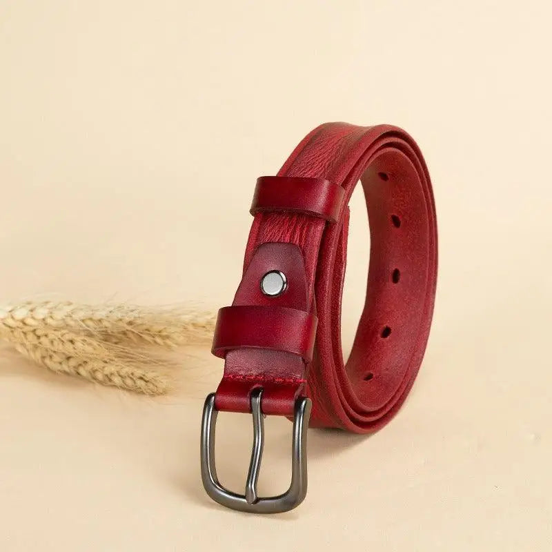 Rolled red leather belt with metal buckle for Anaa Model showcasing premium leather belt design