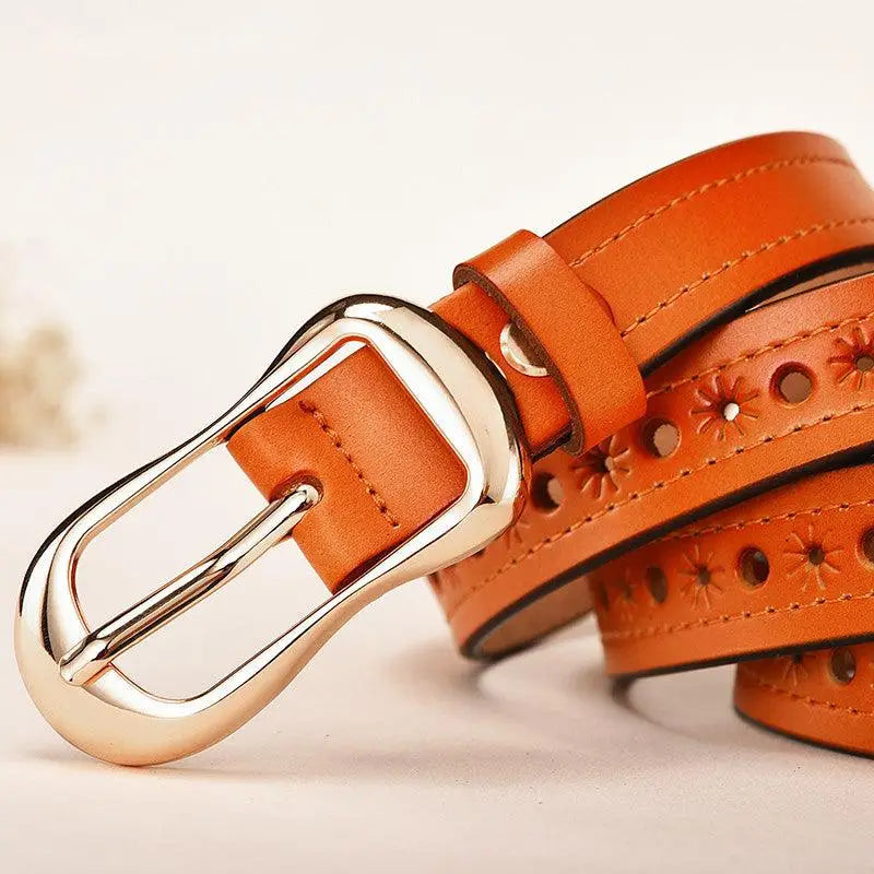 Orange leather belt with floral cutouts and silver buckle from Leather Belts in Various Colors