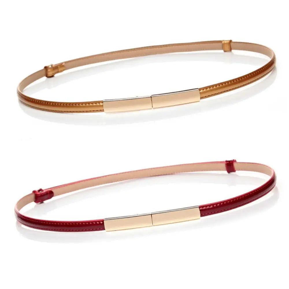 Two thin patent leather belts with gold-colored buckles displayed in a product image
