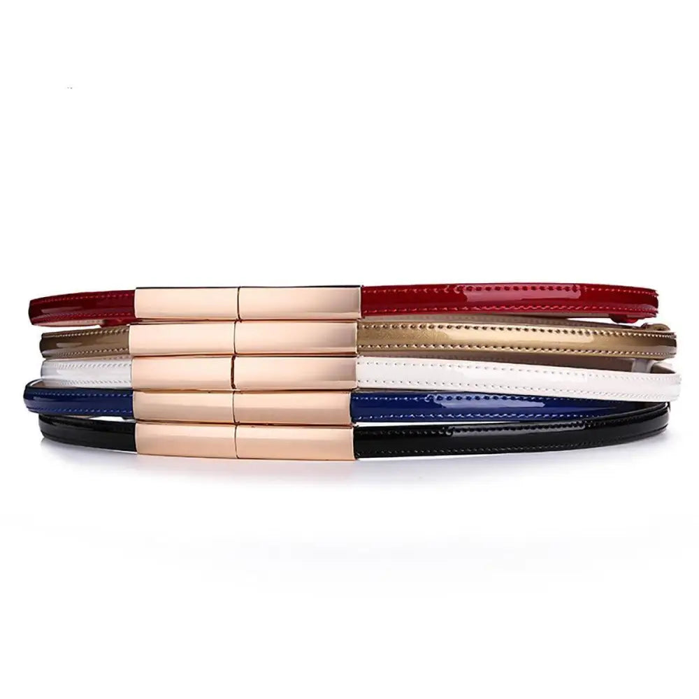 Stacked patent leather belts with gold buckles displayed in the Stackable Patent Leather Belts with Gold Buckle product