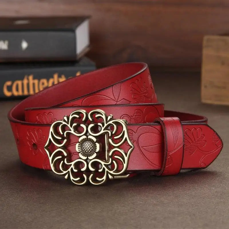 Red leather belt with floral embossing and ornate metal buckle from Leather Belts with Ornate Buckles in Red and Brown