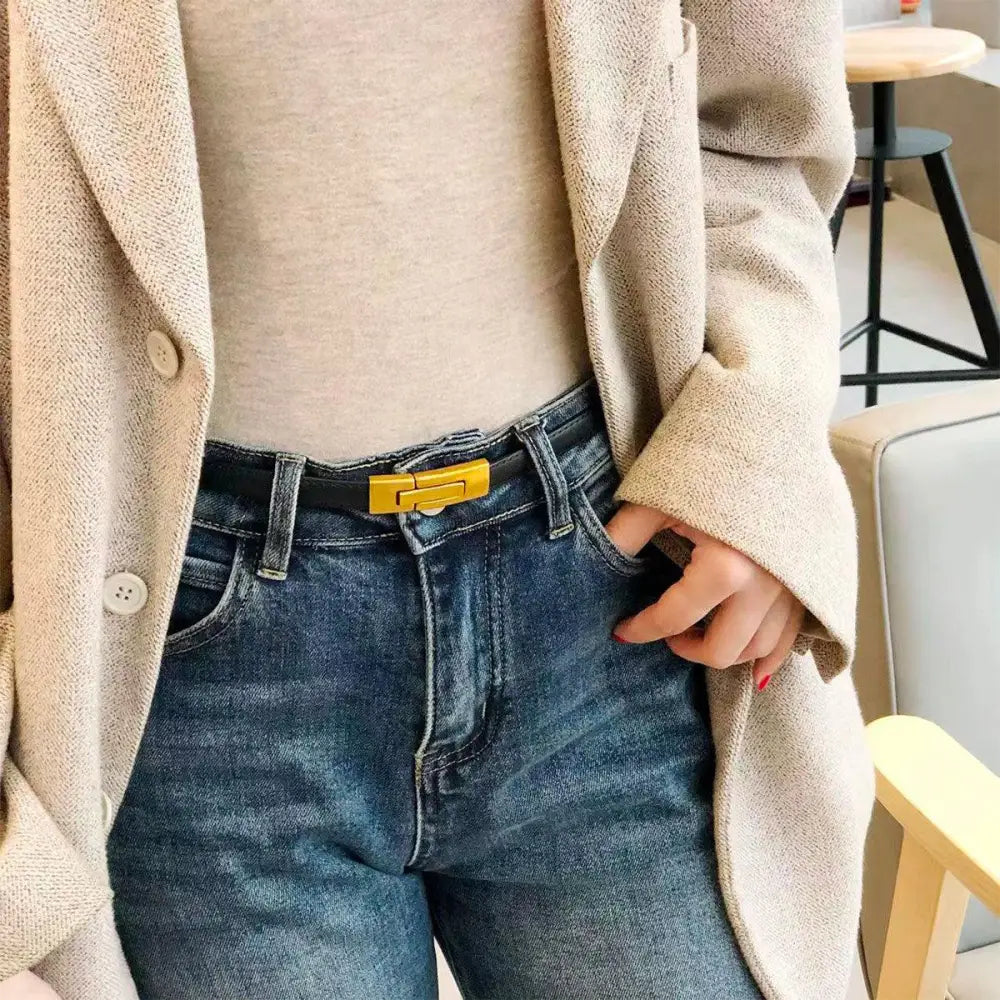 Blue jeans paired with a yellow-buckled leather belt to enhance personal style