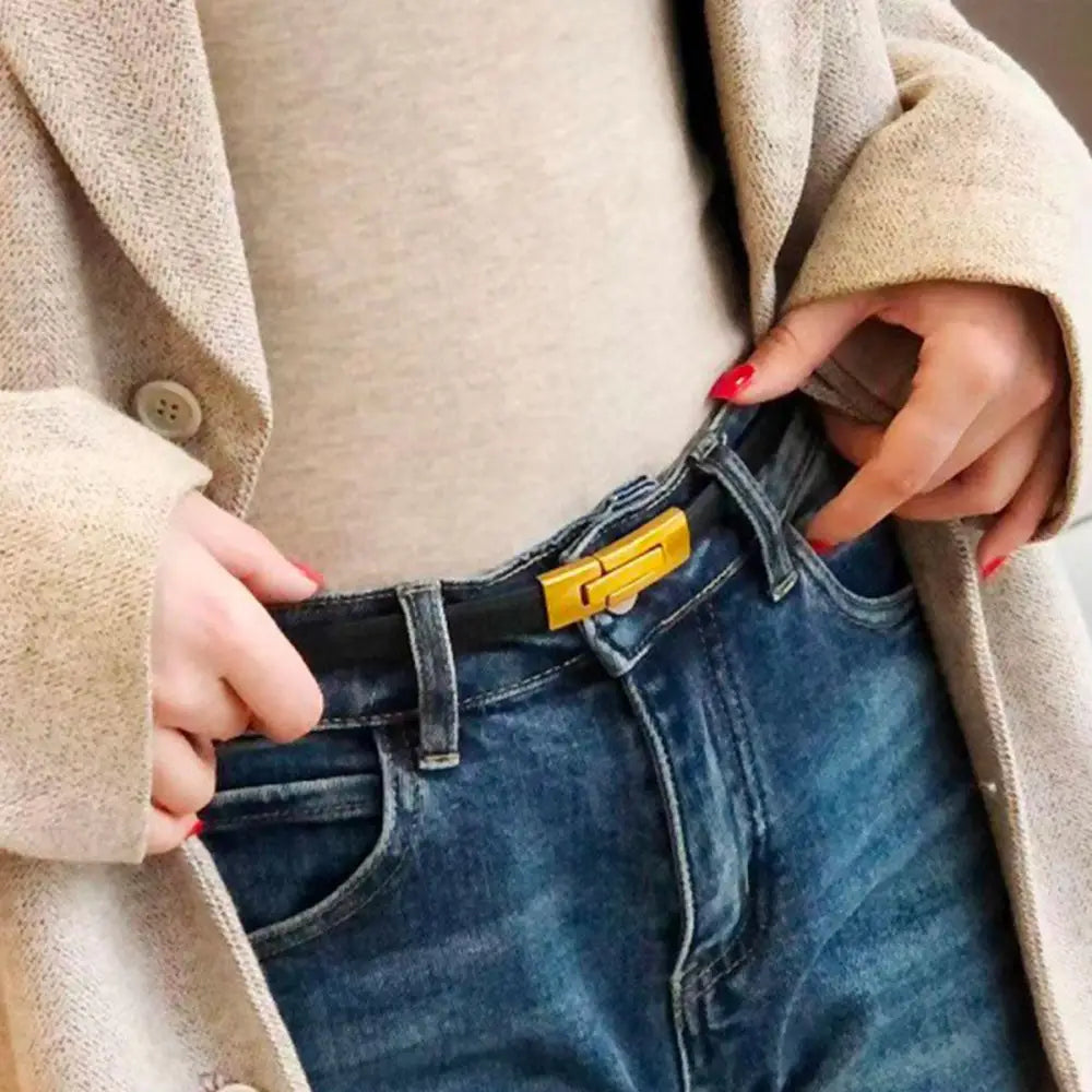 Blue jeans paired with a gold-buckled leather belt to enhance personal style