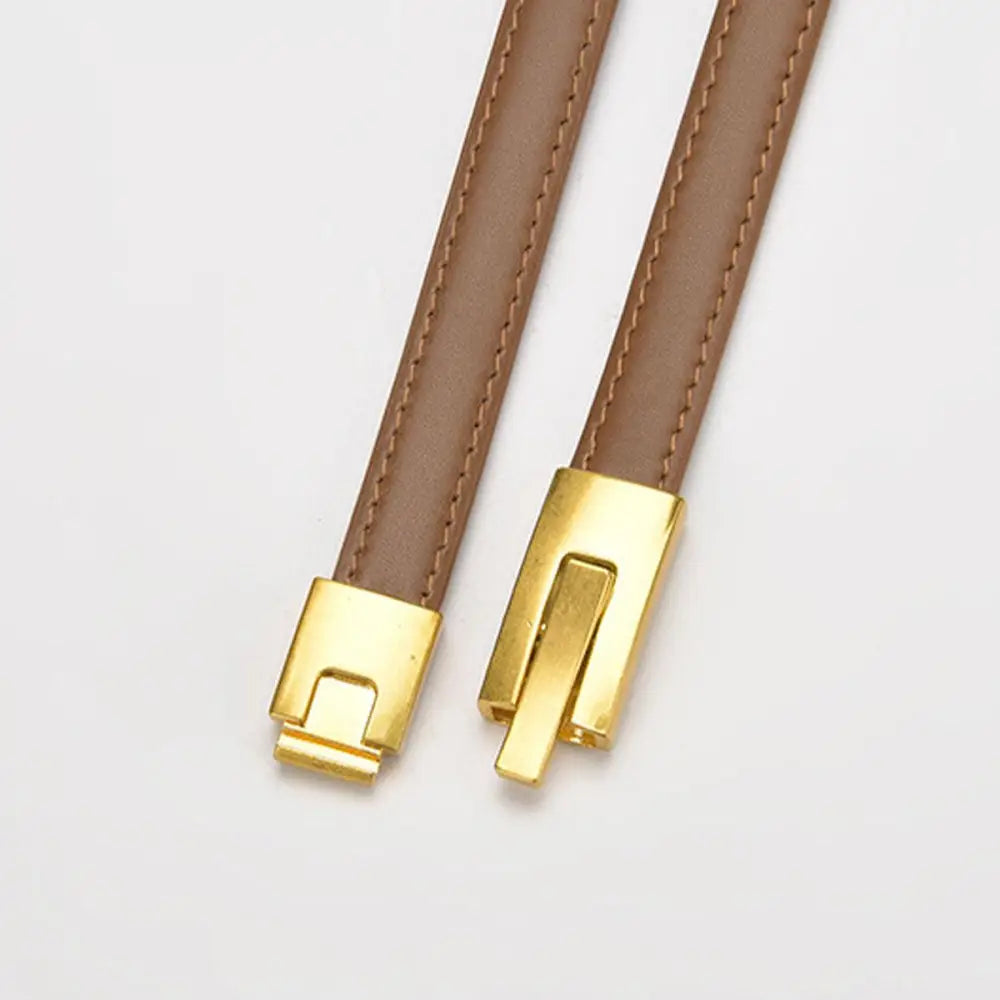 Brown leather straps with gold clasps showcasing stylish leather belts to enhance personal style