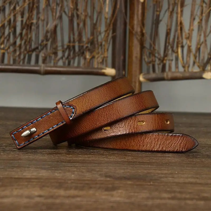 Brown leather belt with stitched edges and silver buckle displayed on a product listing