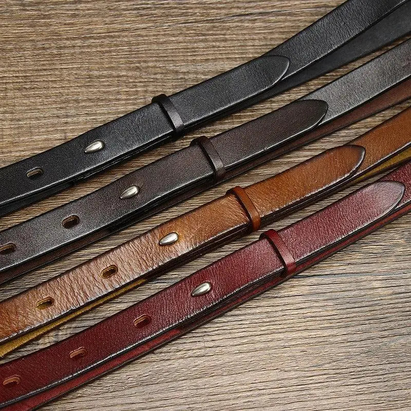 Assorted leather straps with stitched edges and silver buckles for stylish belts