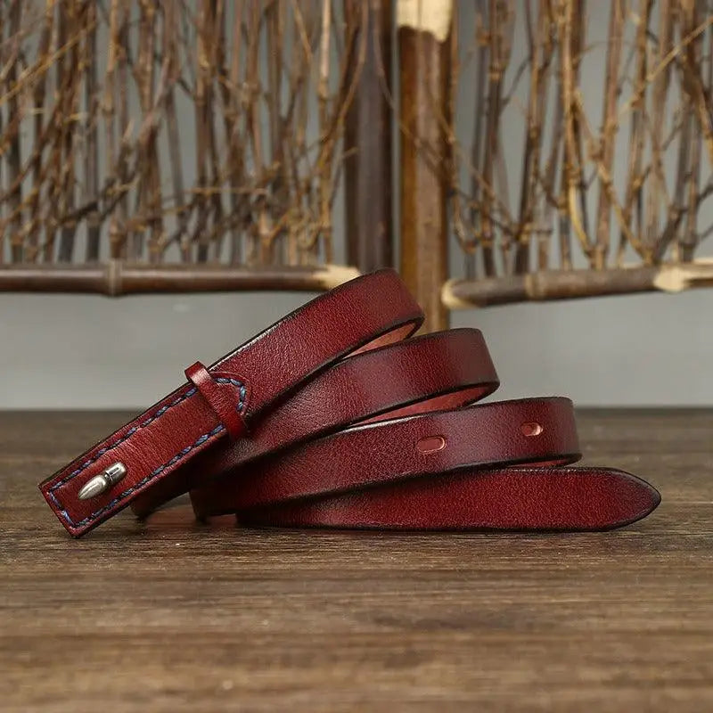 Burgundy leather belt with stitched edges and silver buckle displayed in product image