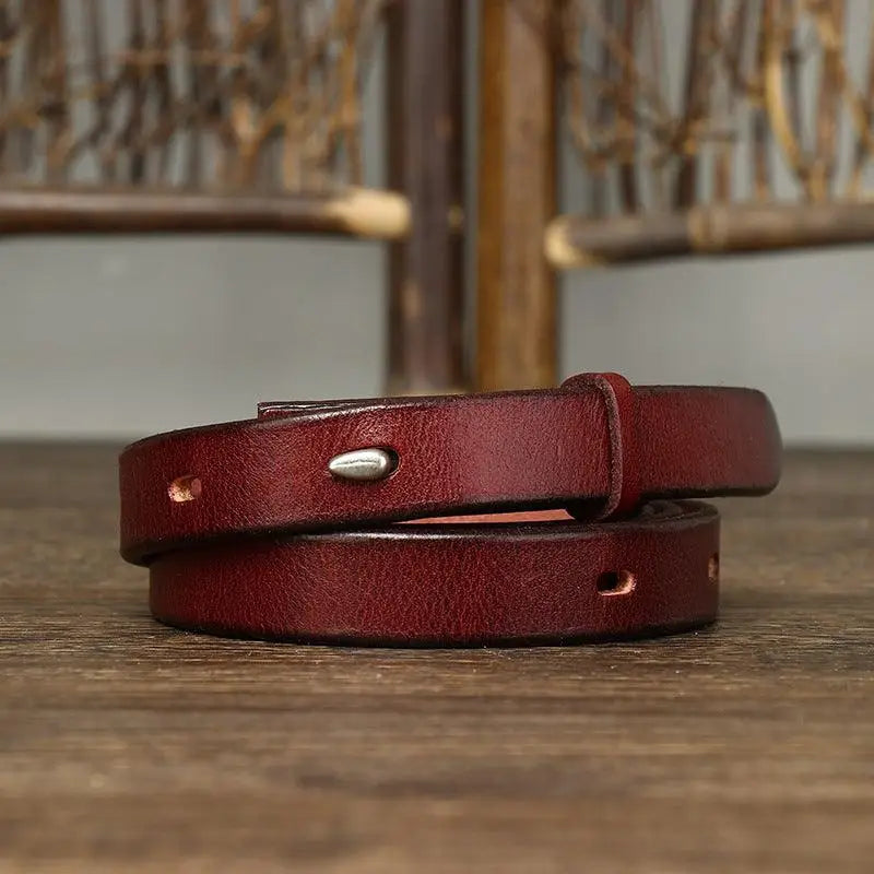 Burgundy leather belt with stitched edges and silver buckle displayed in Leather Belts product