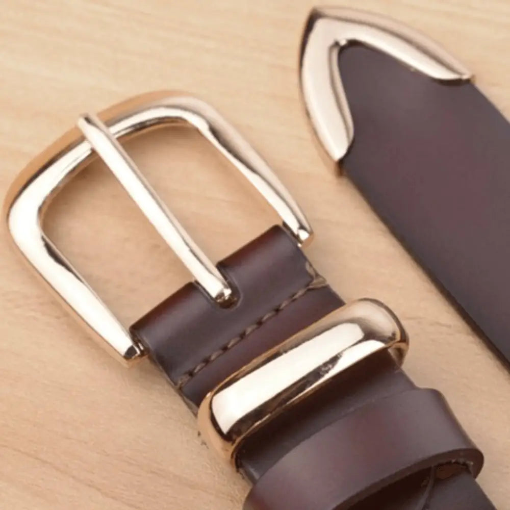 Women’s leather belt with silver buckle and tip, stylish accessory for denim fashion