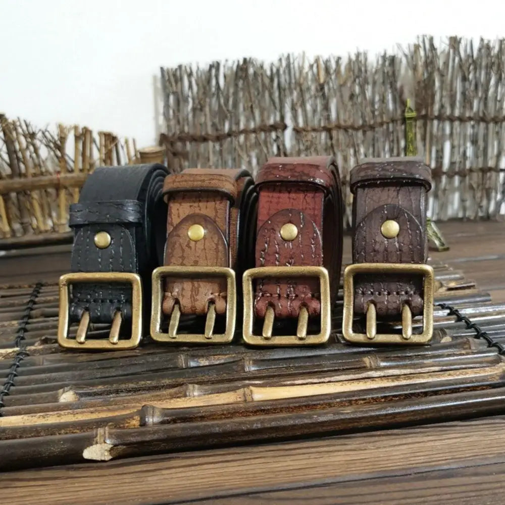 Set of four leather belts with brass buckles displayed for fashionable accessories