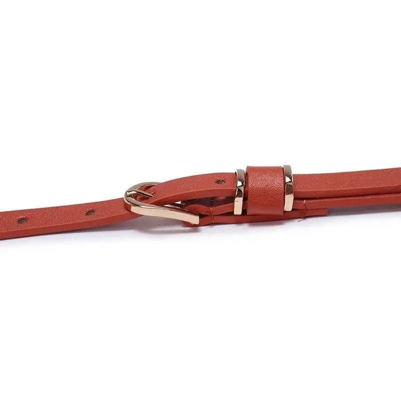 Roxane leather belt with gold buckle complementing ribbed beige choker-neck sweater