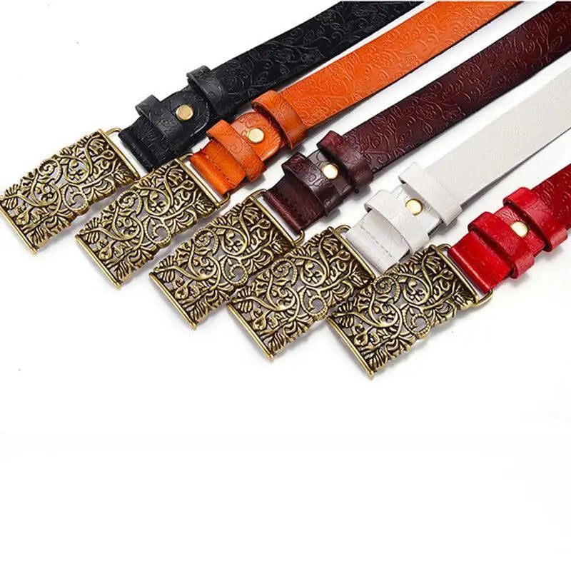 Assorted brown leather belts with ornate gold buckles displayed for women