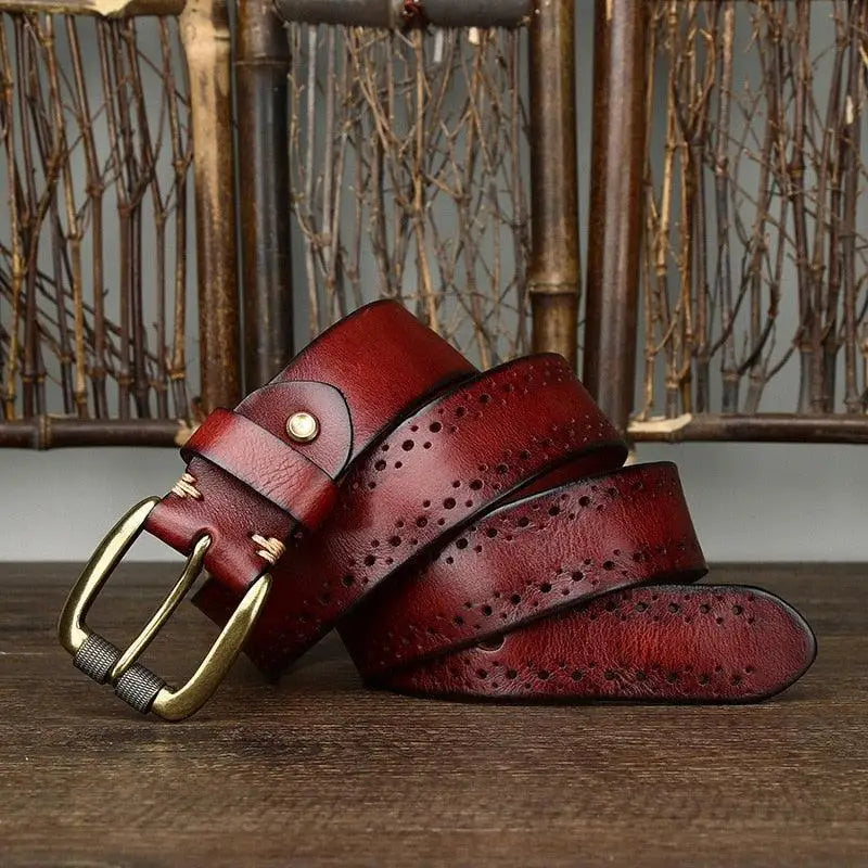 Burgundy leather belt with decorative perforations and brass buckle for stylish wear