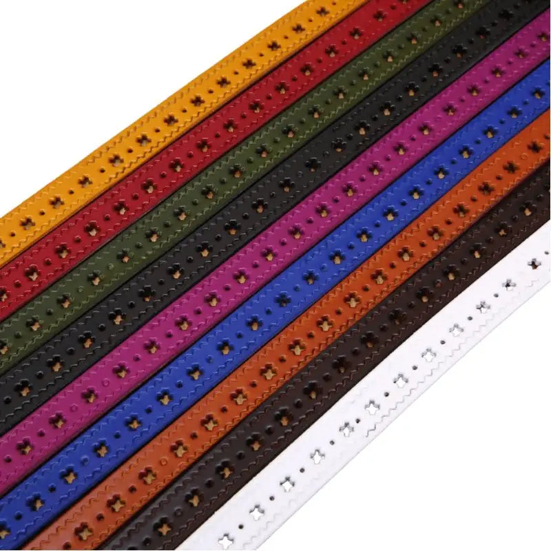 Colorful leather belts with decorative cutouts and buckle options displayed